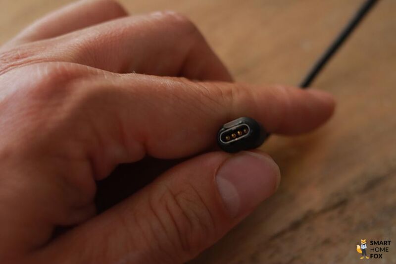 You can see the charging cable of the Garmin Fenix 7.